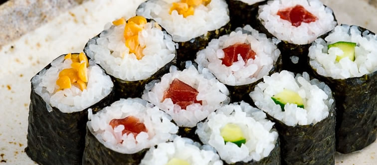 Can you name this iconic Japanese culinary creation that pairs vinegared rice with fresh seafood or other toppings?